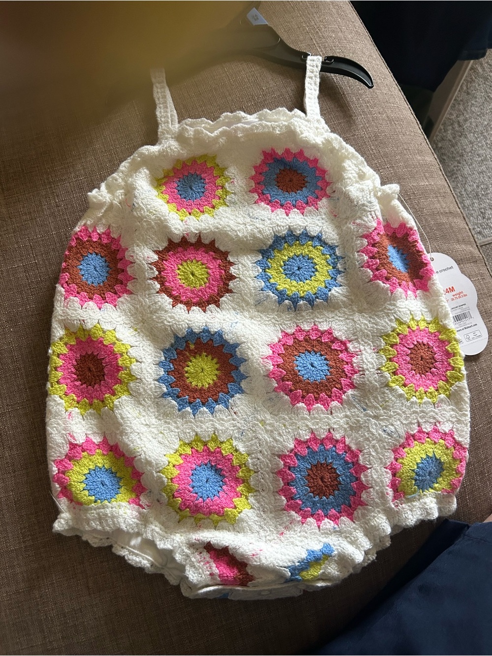 White Crochet-Style Baby Romper with Multicolor Sunburst Motifs